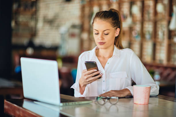 istock Businesswoman sitting in restaurant and using smart phone. 1055133320