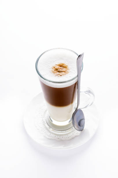 Glass cup served with Capuccino coffee, aromatic coffee from Guatemala served outdoors.