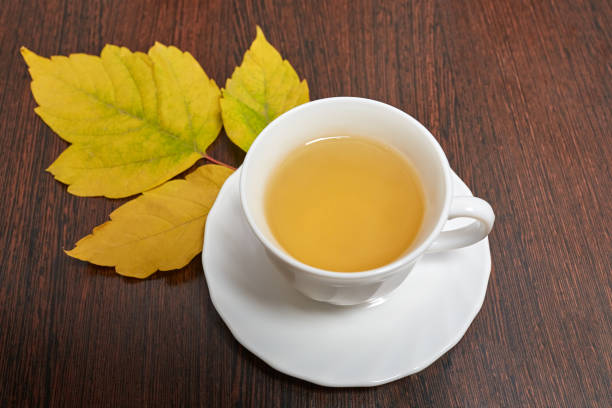 istock a Cup of green tea stands on a brown table 1055135238