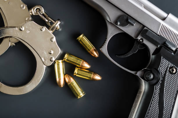 istock Pistol bullets, handgun and handcuffs 1055138272