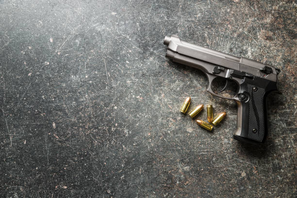 9mm pistol bullets and handgun - armamento imagens e fotografias de stock