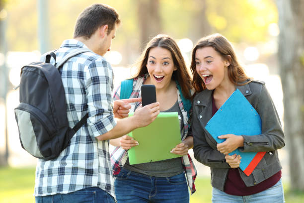 istock Student showing phone content to a friends 1055139876