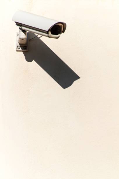 istock Security camera on the wall. Place for text. Big Brother. Property protection. 1055144498