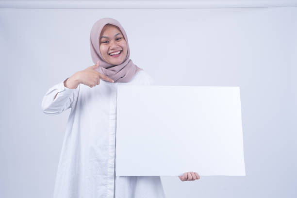 istock Asian Muslim Women with Empty Whiteboard 1055146922
