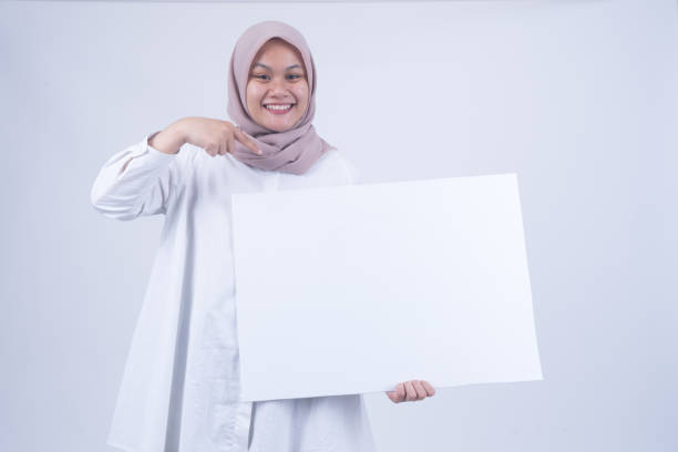 istock Asian Muslim Women with Empty Whiteboard 1055147294
