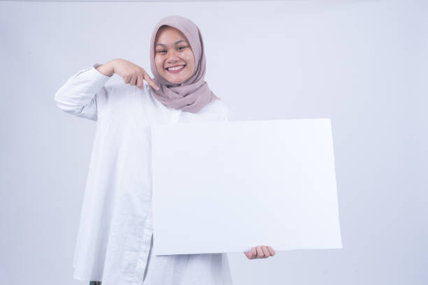 istock Asian Muslim Women with Empty Whiteboard 1055147336