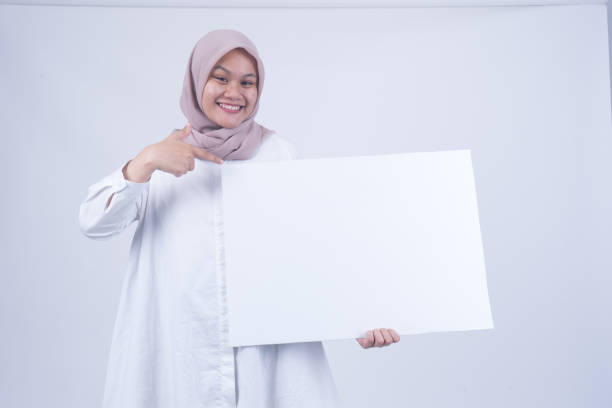 istock Asian Muslim Women with Empty Whiteboard 1055147364