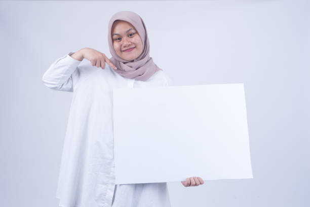 istock Asian Muslim Women with Empty Whiteboard 1055149344