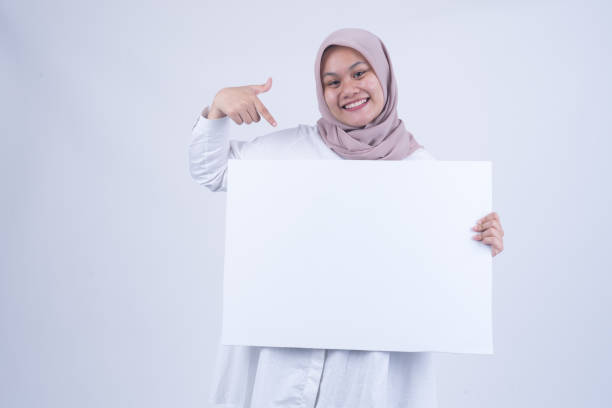 istock Asian Muslim Women with Empty Whiteboard 1055150028