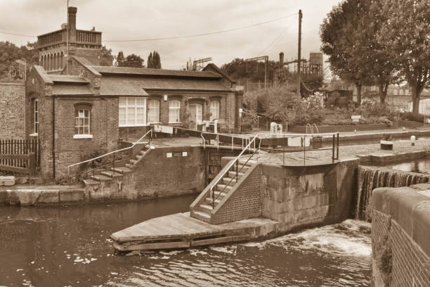 Double Lock Gates at Camden Lock with water gushing through the gap in the gates and lots of shoppers and locals in the background behind the lock gates.