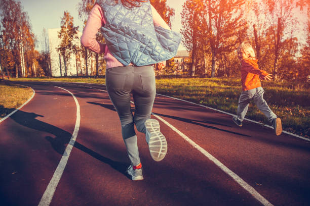 istock woman and boy running at the stadium 1055156630