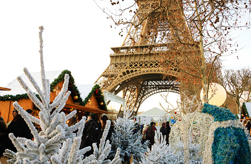 PARIS, FRANCE - DECEMBER 26, 2015: People shopping at Christmas market near Eiffel tower.