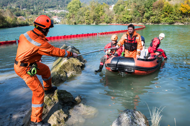 dam construction on the river - rescue operation with a boat, oil spill - rescue imagens e fotografias de stock