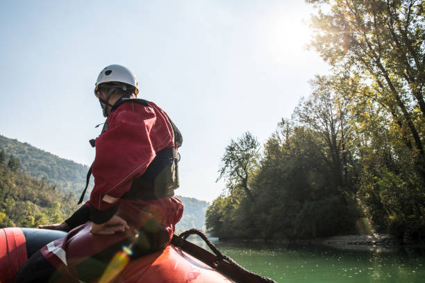 Firefighter in a rescue operation on a rubber boat on the river Firefighters in a rescue operation; all logos removed. Slovenia, Europe. Nikon. flood preparation stock pictures, royalty-free photos & images