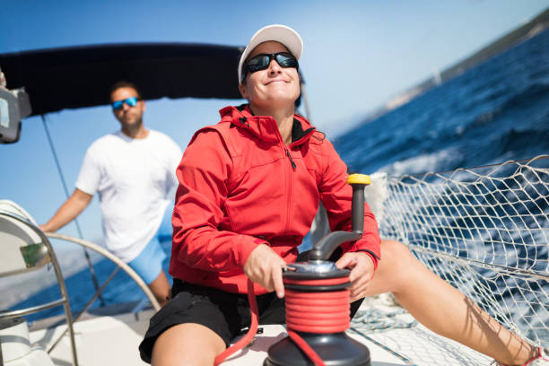 istock Attractive strong woman sailing with her boat 1055167642