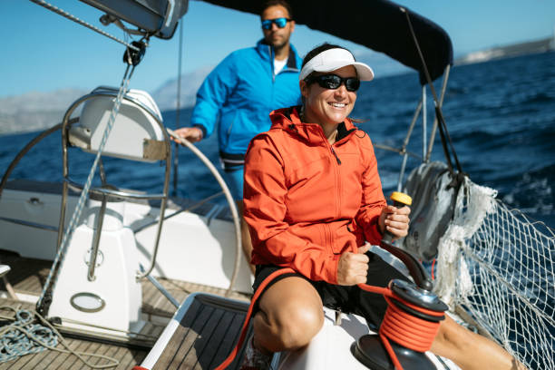 istock Attractive strong woman sailing with her boat 1055167644