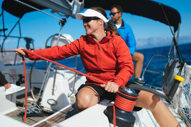 istock Attractive strong woman sailing with her boat 1055167674