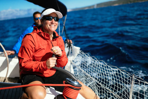istock Attractive strong woman sailing with her boat 1055167696