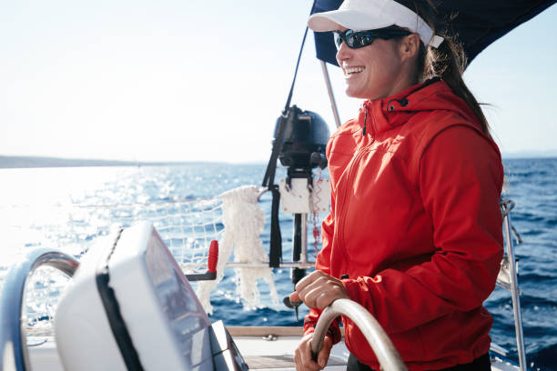 istock Attractive strong woman sailing with her boat 1055168362
