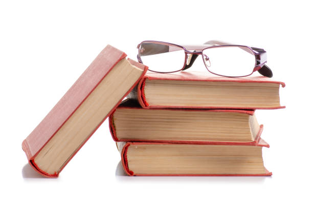 istock Books and glasses for vision in hand 1055173678