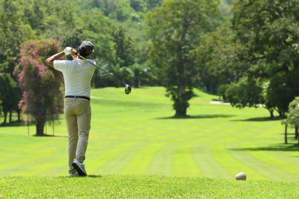 istock Young man playing golf on a beautiful natural golf course 1055181652