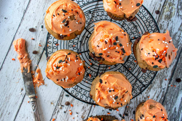 istock Orange and black pumpkin cupcakes 1055182154