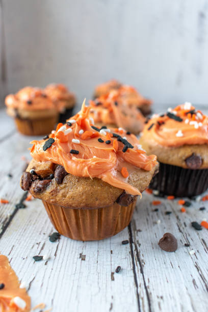 istock Orange and black pumpkin cupcakes 1055182304