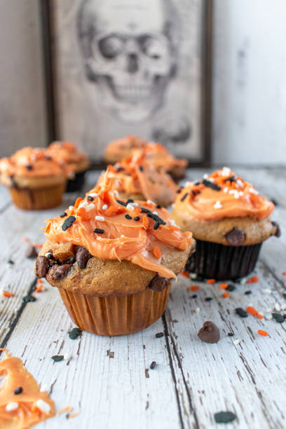 istock Orange and black pumpkin cupcakes 1055182306
