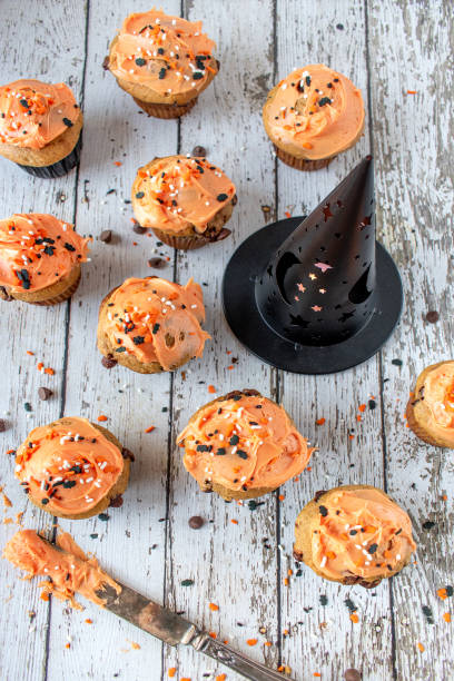istock Orange and black pumpkin cupcakes 1055182488