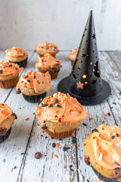 istock Orange and black pumpkin cupcakes 1055182652