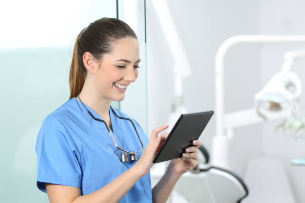istock Dentist consulting online information in a tablet 1055183130