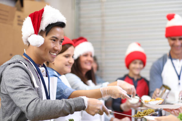 istock Multi-ethnic volunteers serves food at soup kitchen at Christmas. 1055188868