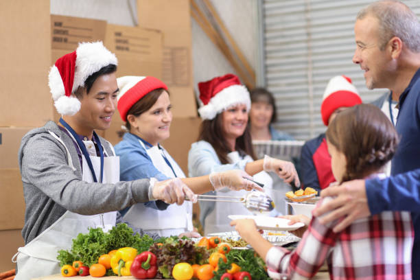 istock Multi-ethnic volunteers serves food at soup kitchen at Christmas. 1055189370