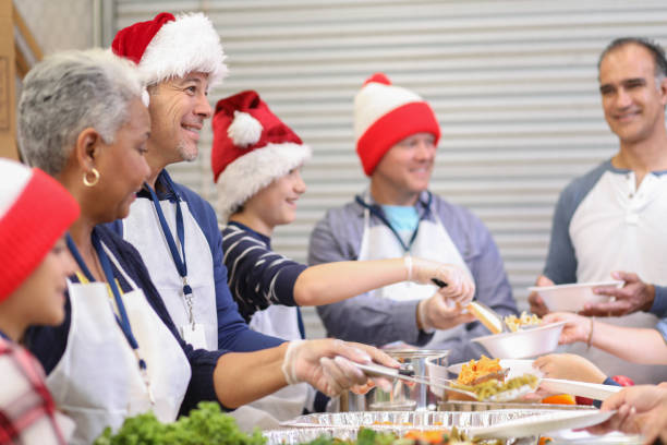 istock Multi-ethnic volunteers serves food at soup kitchen at Christmas. 1055191094