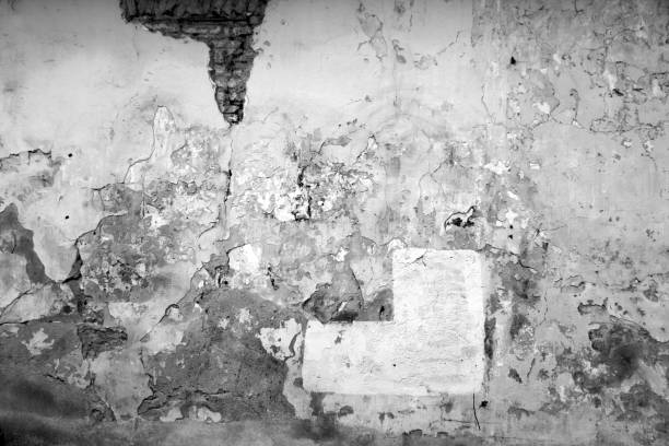 istock craked weathered cement wall texture in black and white. 1055192552