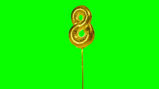 Number eight years birthday anniversary golden balloon floating on green screen