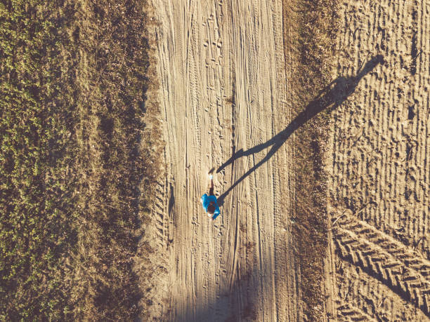 drone view on woman running on field