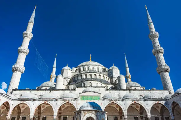 Old and beautiful Sultan Ahmed Mosque (Blue Mosque) Ottoman imperial mosque located in Istanbul, Turkey. Blue sky in background.