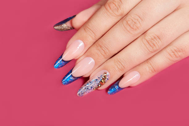 istock Hand with long artificial blue french manicured nails 1055212148