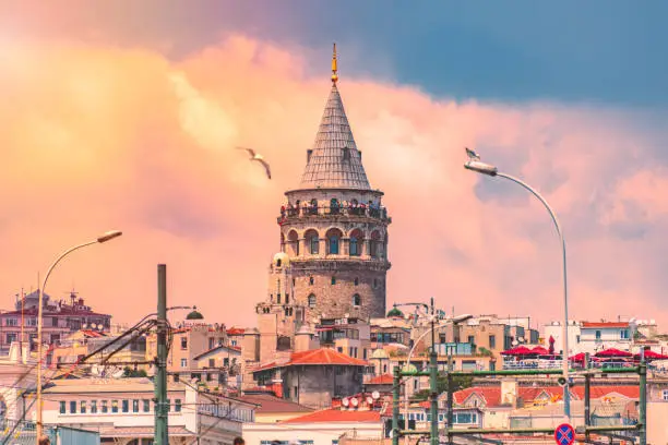 Galata Tower, Christea Turris, medieval stone tower in the Galata/Karaköy quarter of Istanbul, Turkey. Sunset cloudy sky in background.