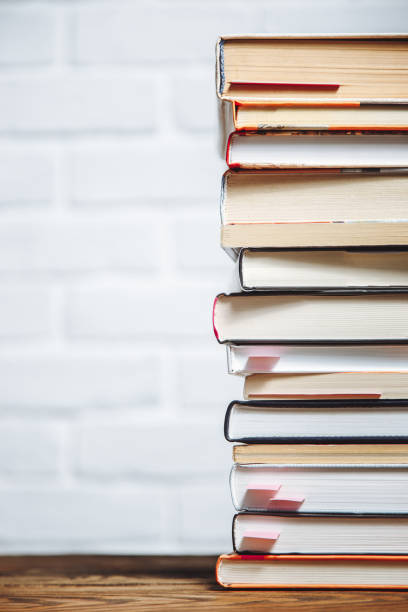 istock Stack of hardback books on wooden table. Back to school. Copy space for text 1055213452