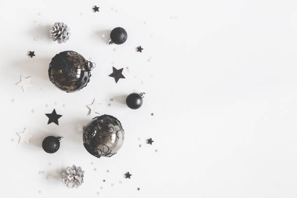 istock Christmas composition. Christmas black and silver decorations on pastel gray background. Flat lay, top view, copy space 1055213694