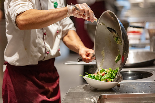 Close-up of chef preparing fresh salad