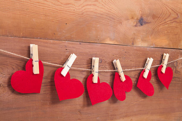 Tiny red heart sign isolated on wooden background. Red heart sign isolated on wooden background. Heart broken, love and valentines day concept. pulse orlando night club & ultra lounge stock pictures, royalty-free photos & images