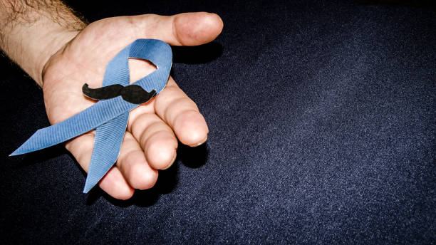 istock Man holding a blue ribbon, blue november concept 1055215704