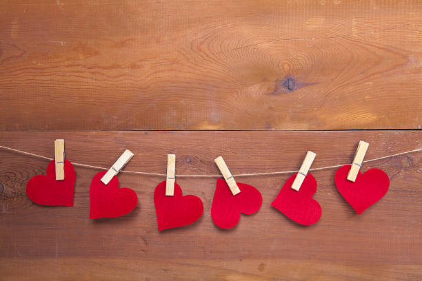 Tiny red heart sign isolated on wooden background. Red heart sign isolated on wooden background. Heart broken, love and valentines day concept. pulse orlando night club & ultra lounge stock pictures, royalty-free photos & images