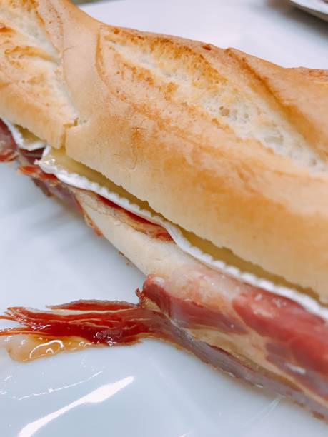 istock spanish iberian ham and brie cheese sandwich 1055220196