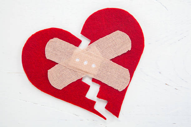 Tiny red heart sign isolated on wooden background. Red heart sign isolated on wooden background. Heart broken, love and valentines day concept. pulse orlando night club & ultra lounge stock pictures, royalty-free photos & images