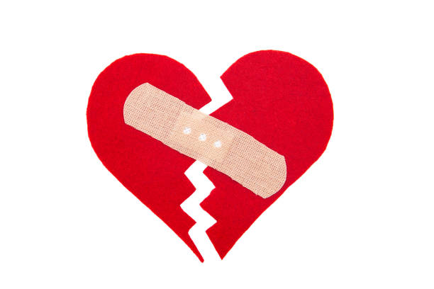 istock Tiny red heart sign isolated on wooden background. 1055221654