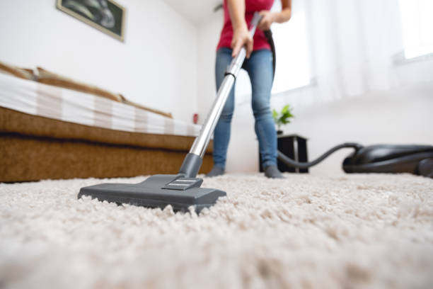 young woman vacuuming house - vacuum cleaner imagens e fotografias de stock